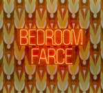 Bedroom Farce is written in neon lights on top of an orange and brown 70s style pattern wallpaper.